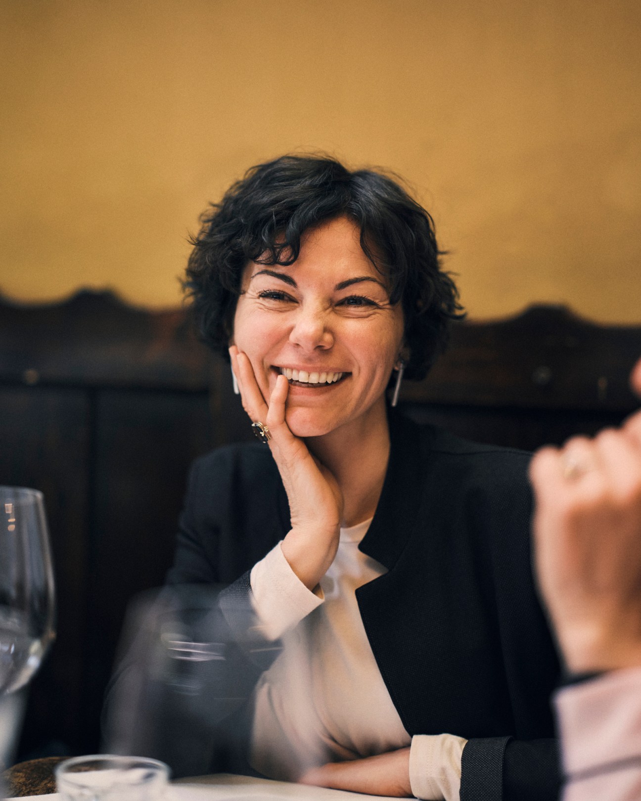Chiara Speri from Speri winery smiling warmly while resting her chin on her hand during the wine producers discussion