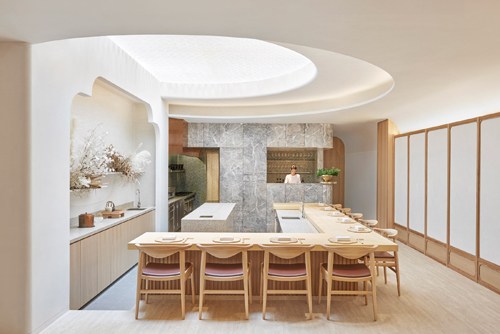 Modern restaurant counter at Esora in Singapore with wooden seating and contemporary design.