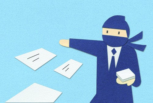 Business figure in blue suit pointing at scattered white cards or documents on blue surface