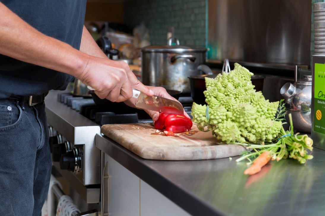 Ari Weinzweig cooking vegetables in his kitchen