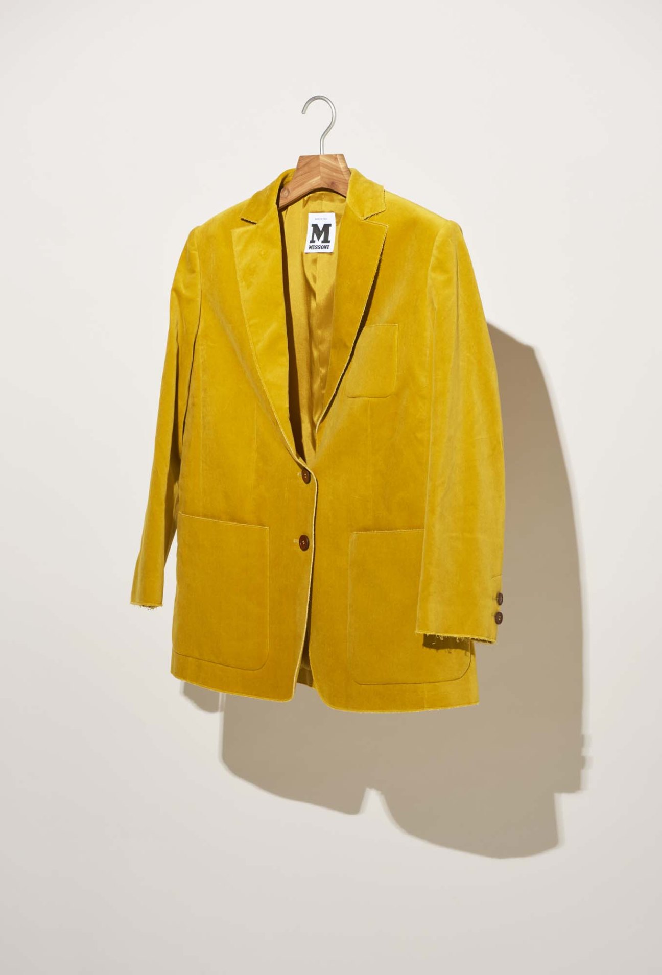 M Missoni yellow blazer on wooden hanger against white background