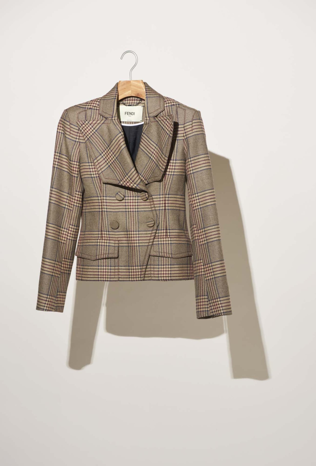 Fendi check blazer on wooden hanger against white background