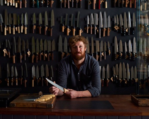 Tom Saunders in Kitchen Provisions shop in London displaying Japanese knives and kitchen tools