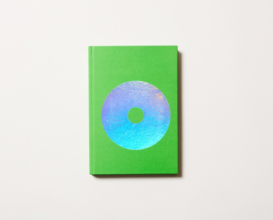 Green hardcover book with gradient blue-to-cyan circular disc design on front cover.