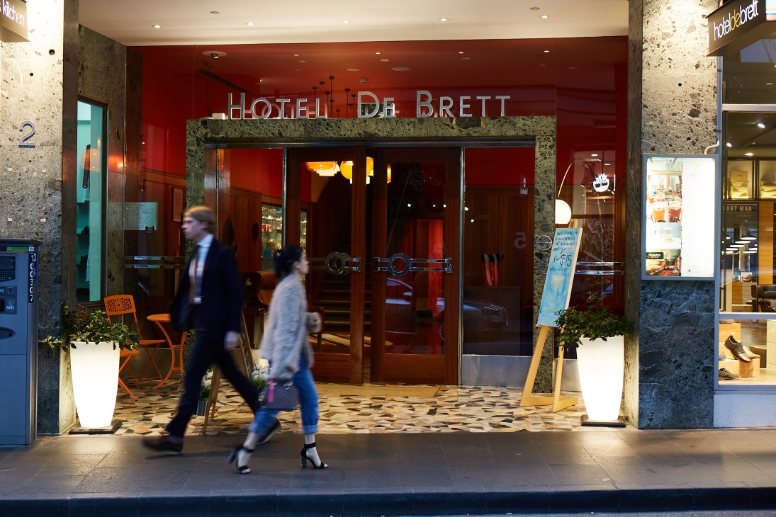 Hotel DeBrett storefront with red facade and mid-century modern signage on Auckland street.