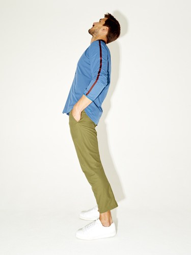 Male model wearing a blue shirt and olive-green trousers from Descente DDD.