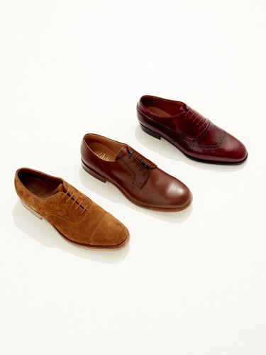 Three lace-up oxford shoes in tan suede, brown leather, and burgundy leather displayed in a row.