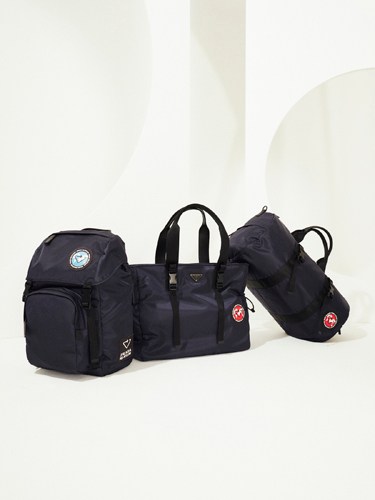 Three black nylon backpacks and tote bags displayed against a white background.
