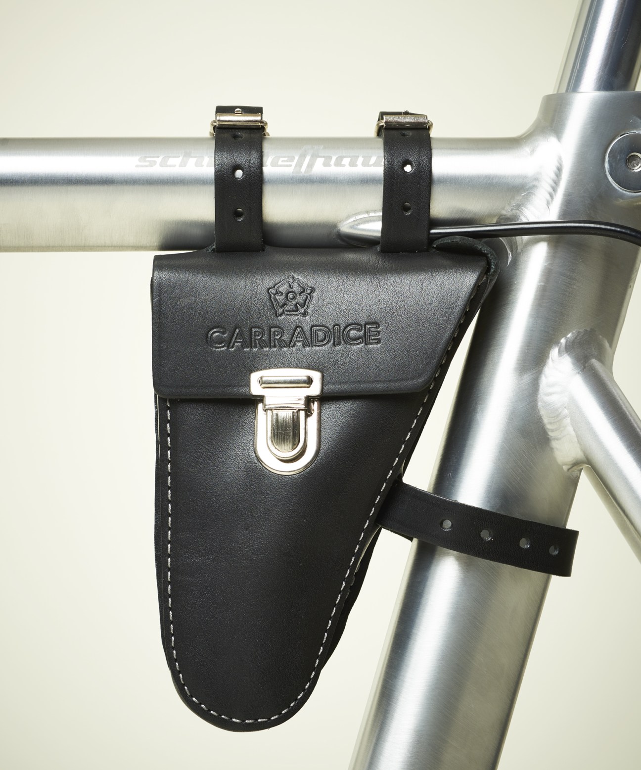 Carradice black leather frame-fitting pouch mounted on bicycle frame.