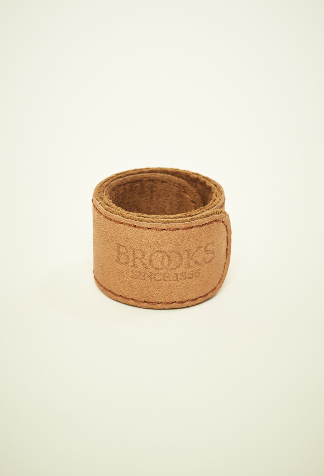 Brooks England tan leather trouser strap with embossed branding.