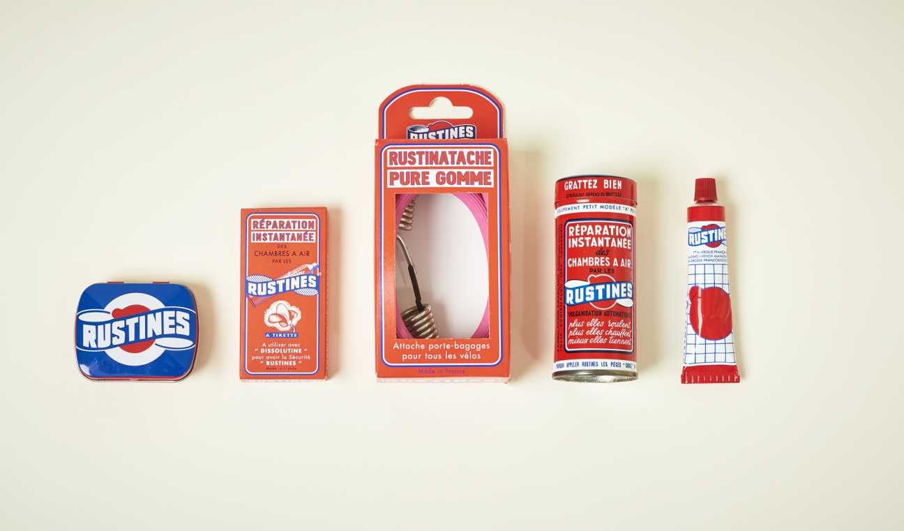 Collection of vintage Rustines French bicycle repair and maintenance products including adhesive patches, rubber gum, and repair tape.