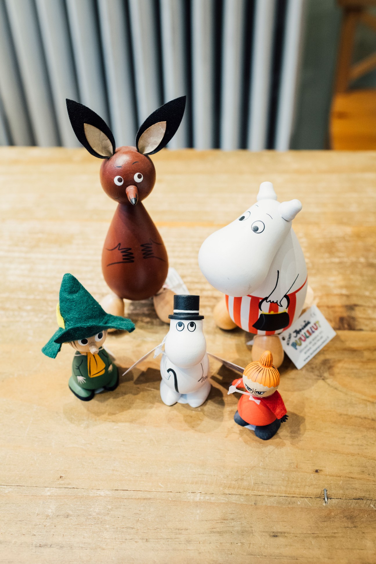 Moomin and Jukka toy figures displayed on a wooden table at Tingeling toy shop in Helsinki.