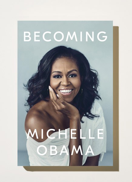 Book cover of 'Becoming' by Michelle Obama featuring a portrait photograph of the author smiling.