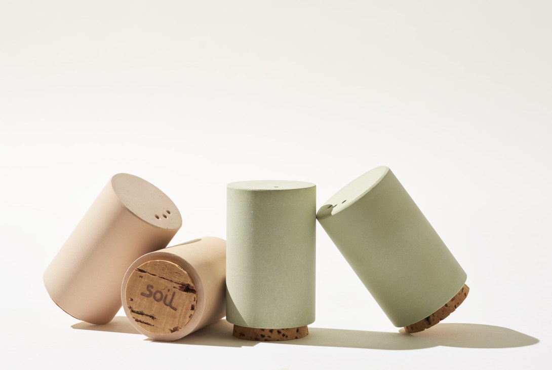 Three cylindrical salt and pepper shakers in natural earth tones with cork bases by Soil.