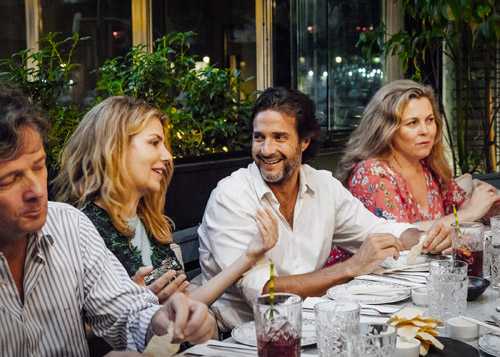 People dining together at a table during a shared meal in Madrid.