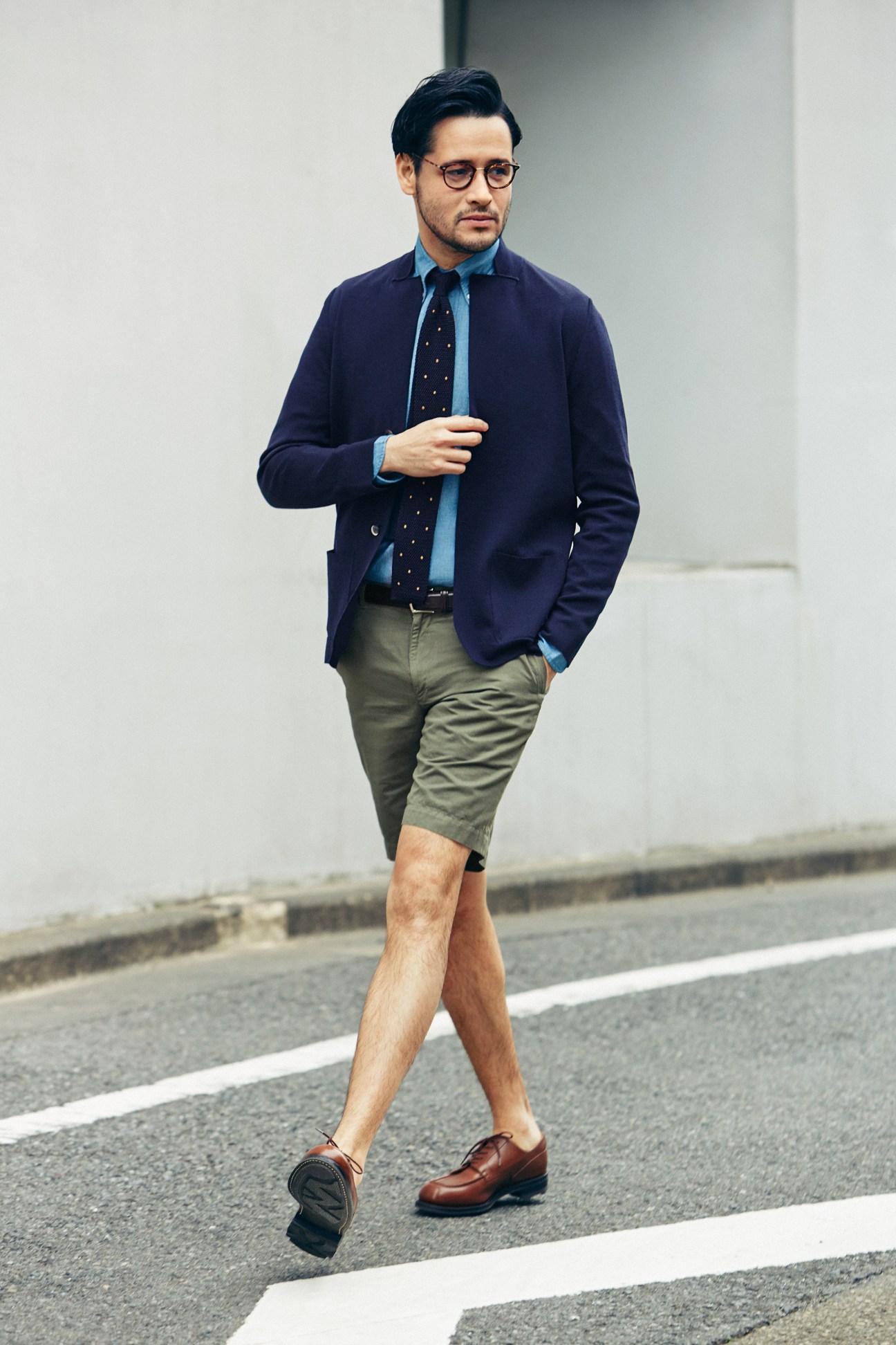 Man wearing navy Drumohr jacket, Drake's shirt, Sunspel shorts, JM Weston shoes, Eyevan 7285 glasses, Boglioli tie and D'amico belt.