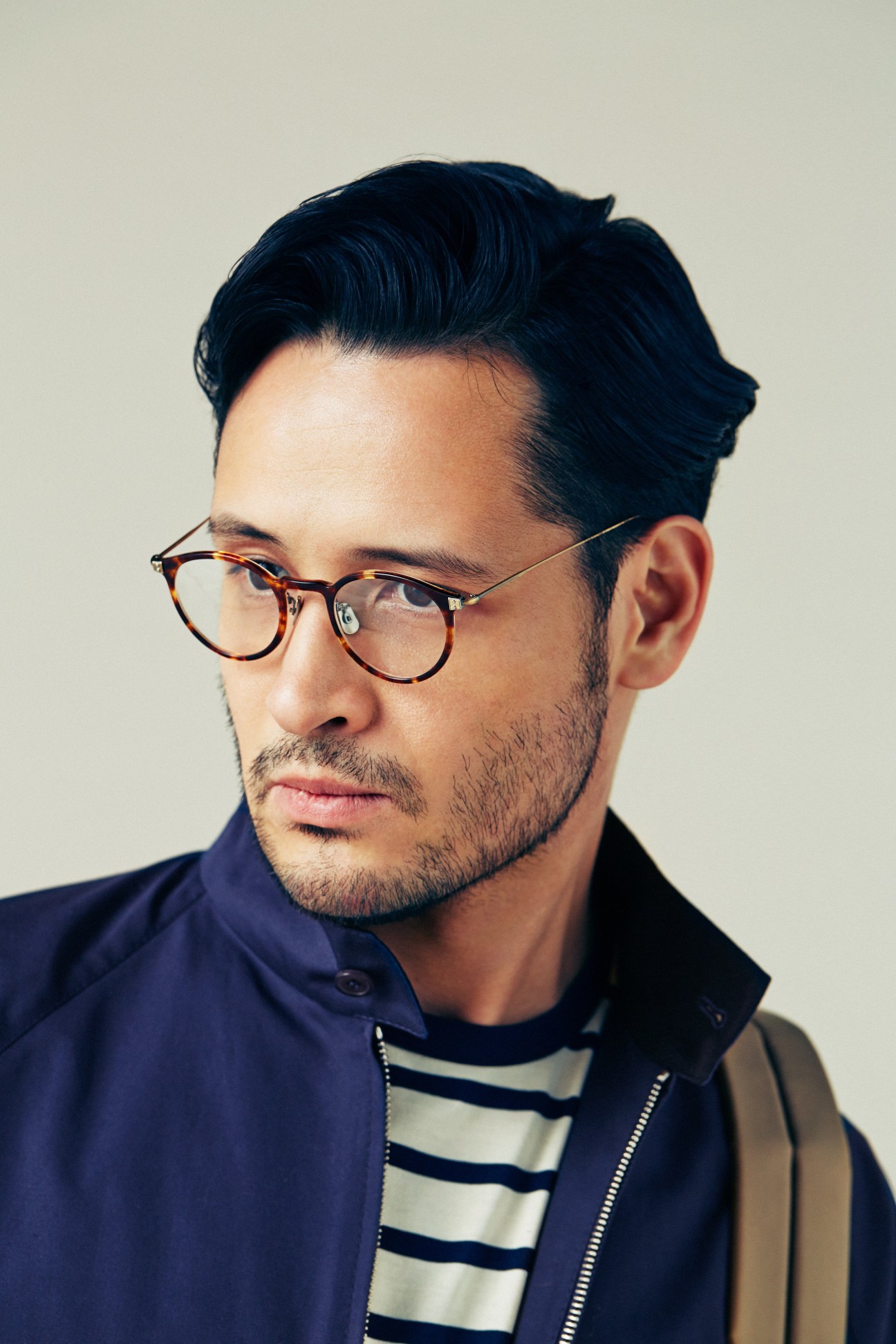 Man wearing Prada jacket, Sunspel T-shirt, and Eyevan 7285 glasses for spring 2018 lookbook.