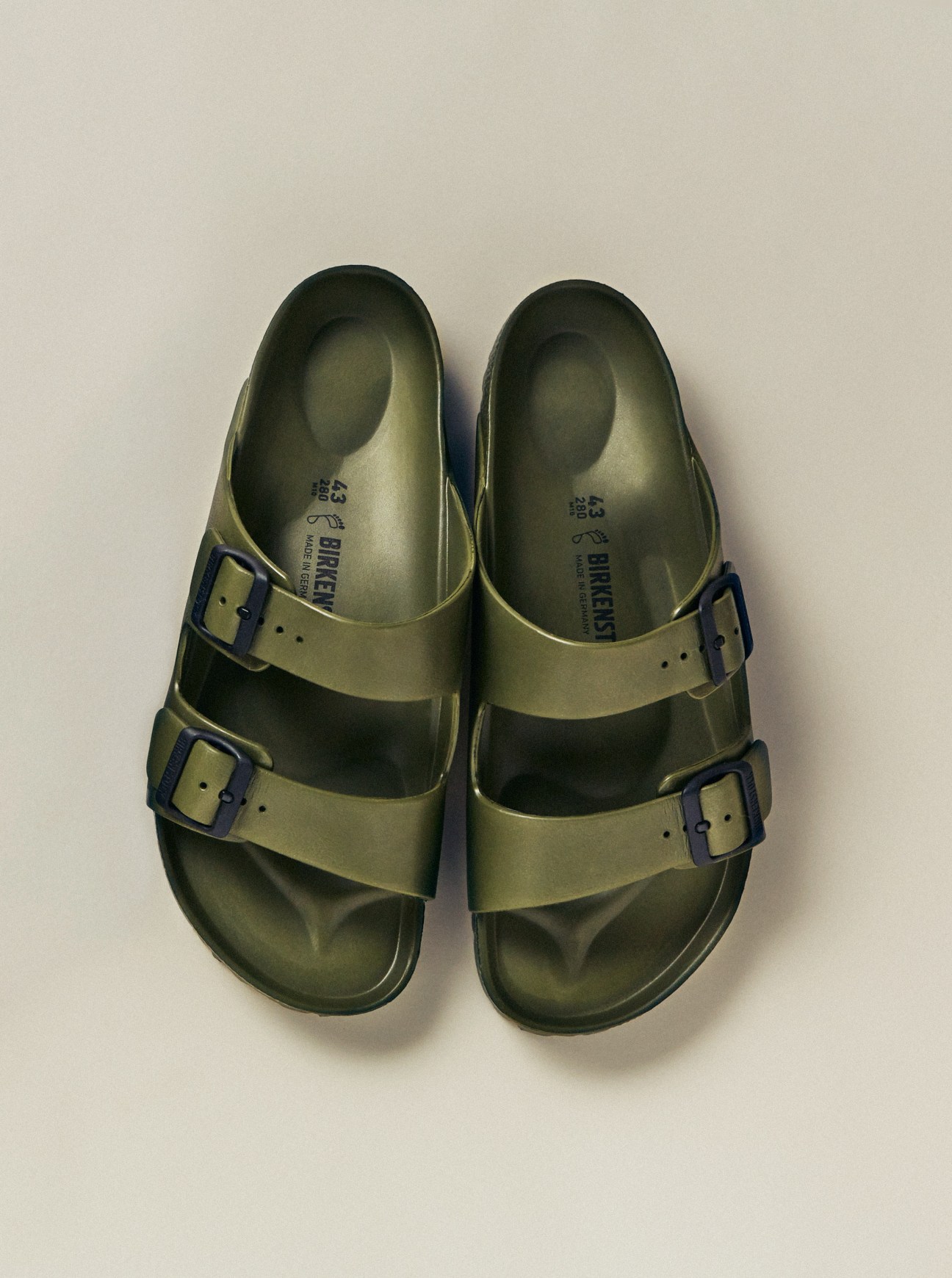 Pair of olive-green Birkenstock EVA sandals with dual buckle straps viewed from above.