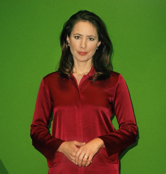 Belle Donati, news anchor at Euronews, wearing a red shirt against a green background.