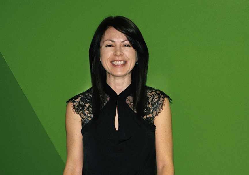 Sarah Taylor, senior producer at Euronews, smiling against a green background.