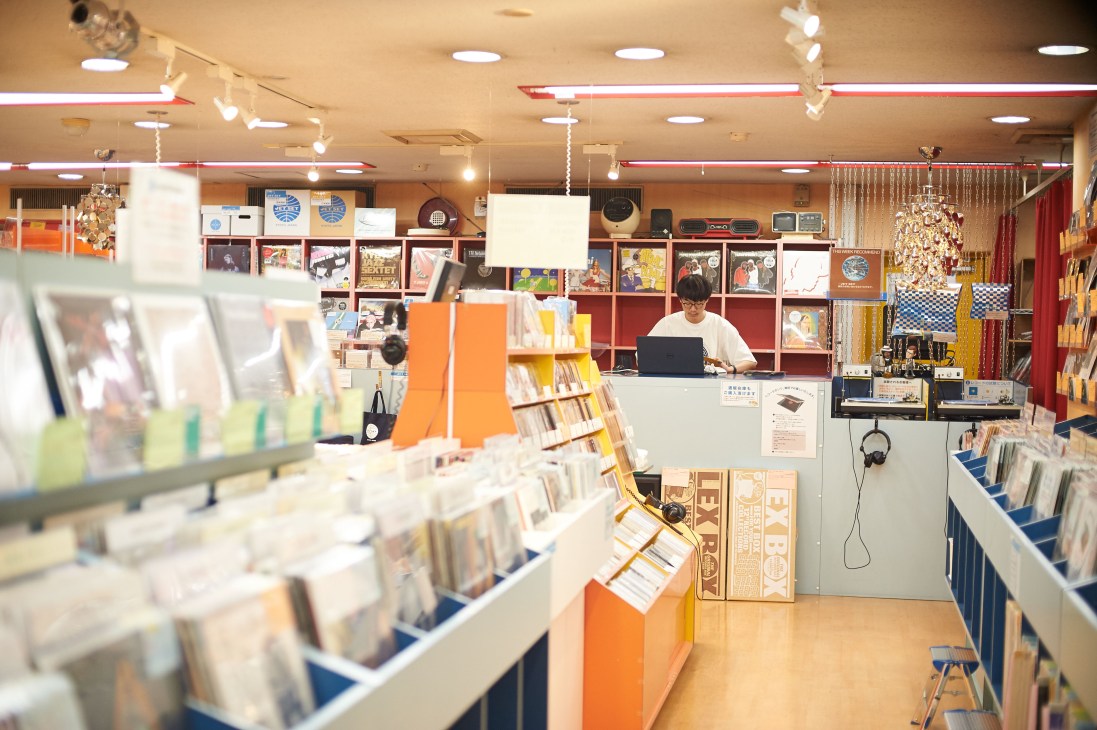 Interior of Jet Set Kyoto record store with vinyl records on display and staff member at counter.