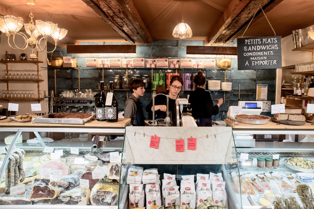 Interior of Château d'If gift shop with staff behind counter and display cases of local products.