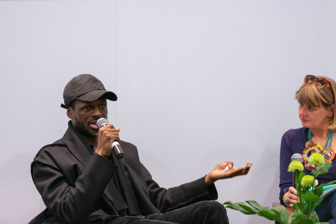 Model and designer Imane Ayissi discusses African textiles with anthropologist Anne Grosfilley at Le Carreau du Temple.