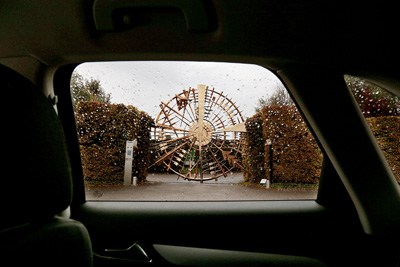 Bronco gate sculpture viewed through car window at Ca' del Bosco vineyard.