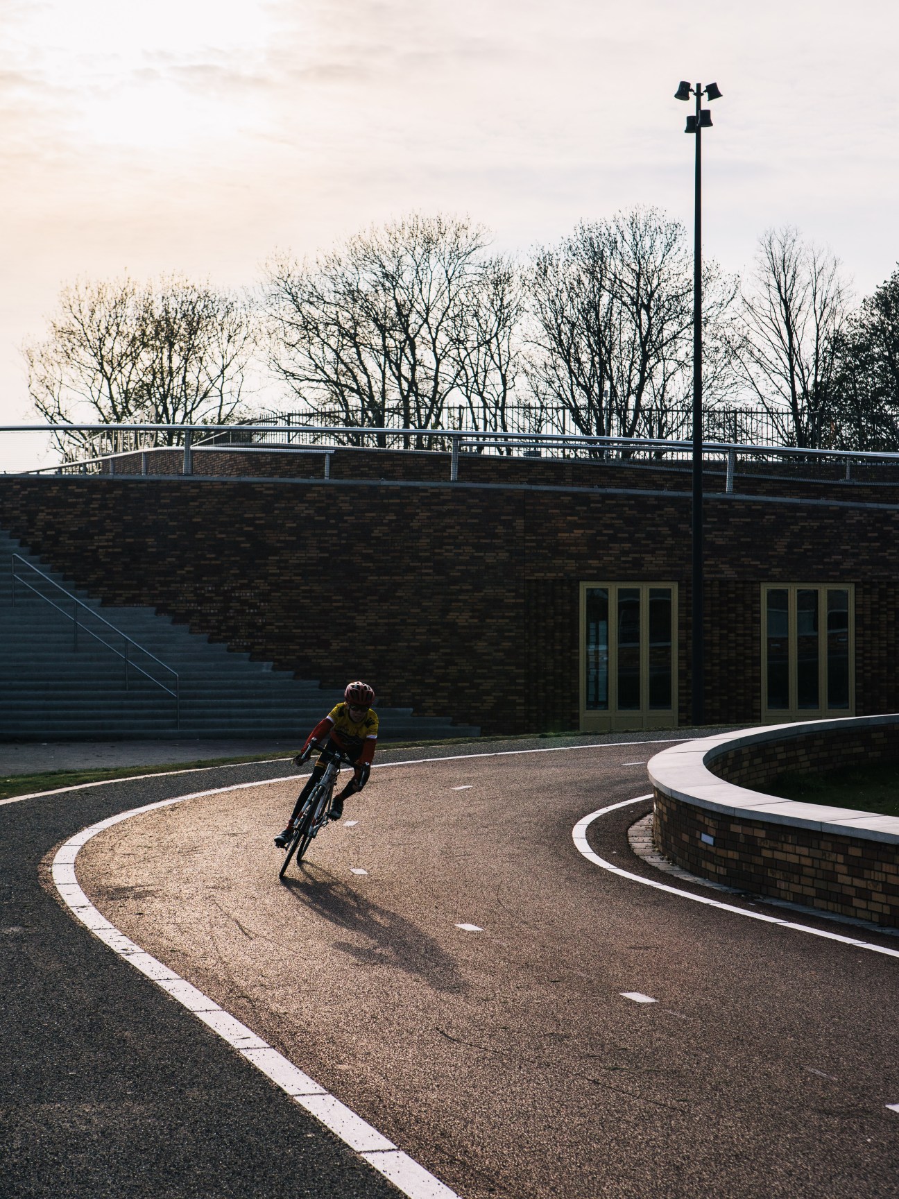Cyclist riding on curved path near Dafne Schippers bridge in Utrecht.