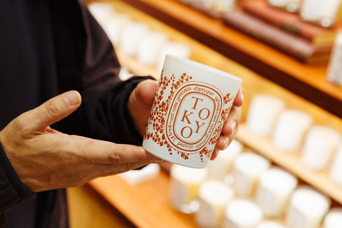 Hand holding Tokyo scented candle from Diptyque Aoyama fragrance store