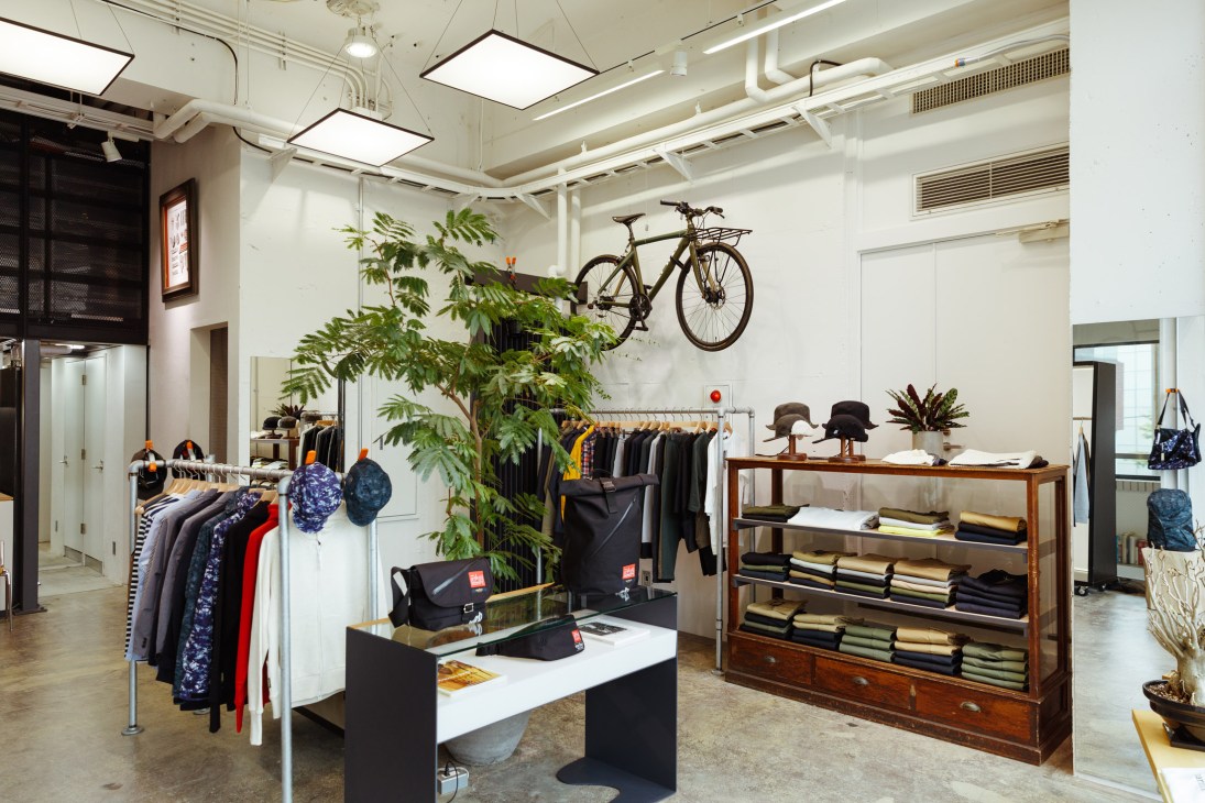 Narifuri bicycle shop interior displaying bikes, cycling clothing, and accessories across two stories.