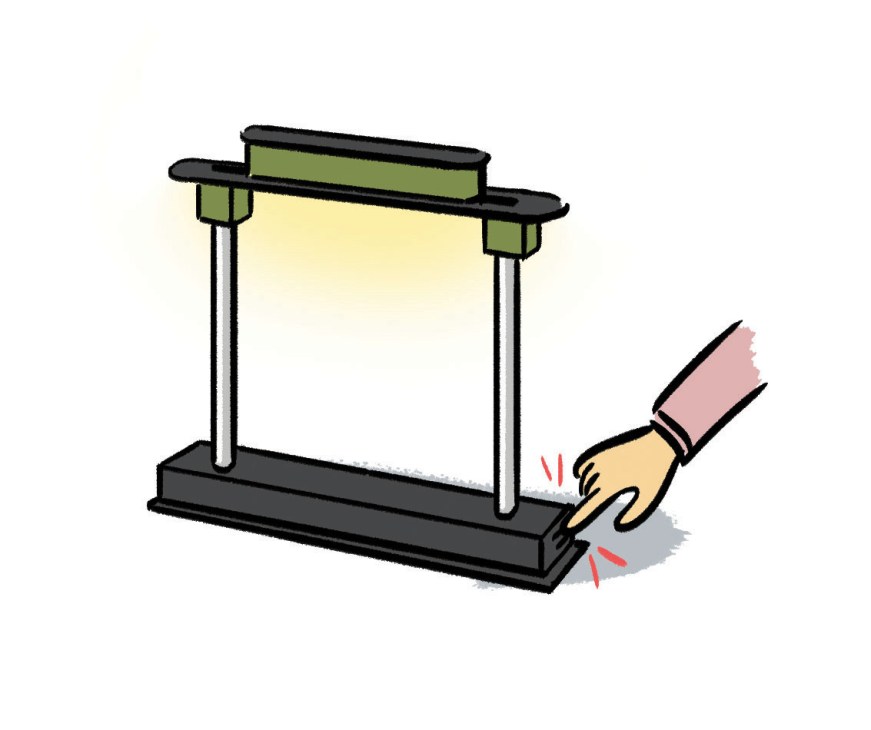 Illustration of a hand adjusting a desk lamp on a display stand.