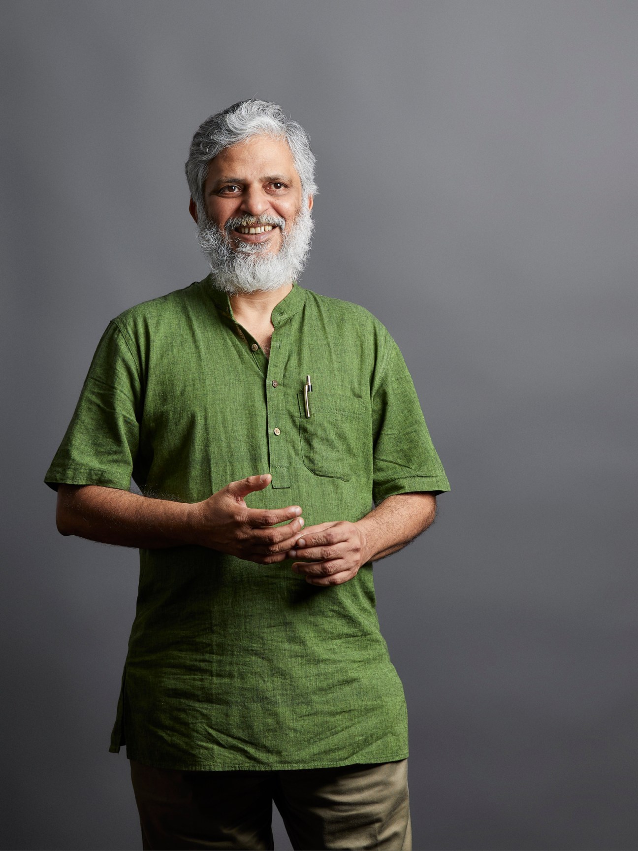 Shankar Raghuraman, senior editor with Times Insight Group, wearing a green shirt and smiling at the camera.