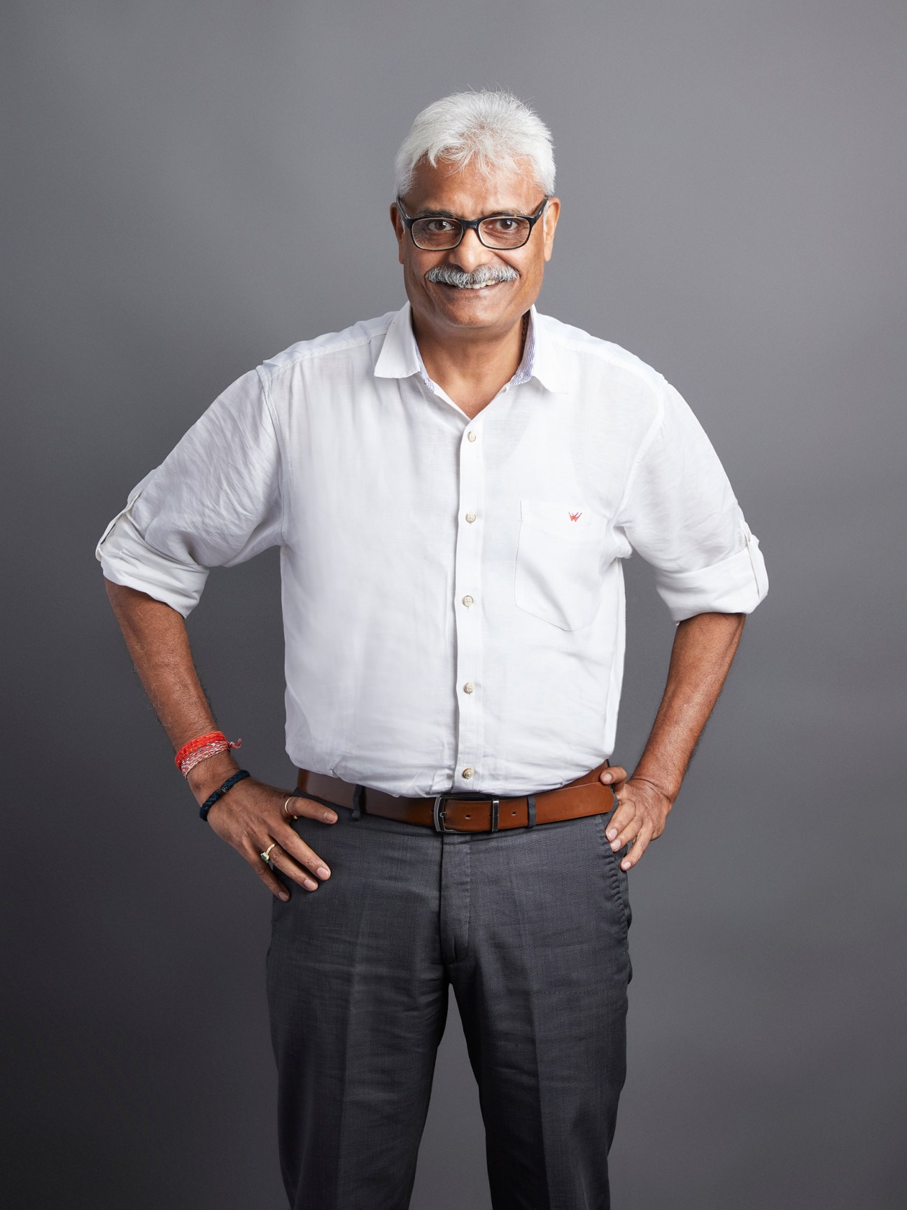 Diwakar Asthana, executive editor at Times of India, wearing glasses and white shirt with brown belt.