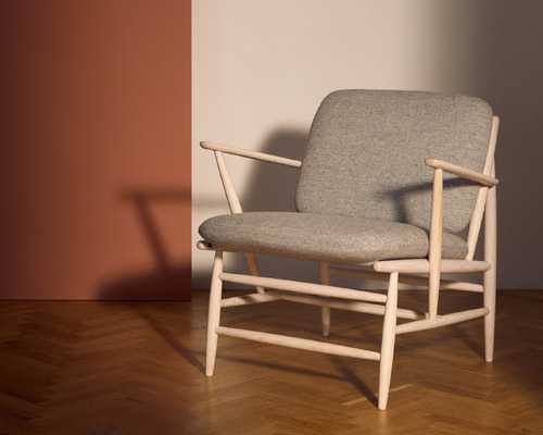 Von armchair by Ercol in light wood with grey upholstered seat and back.