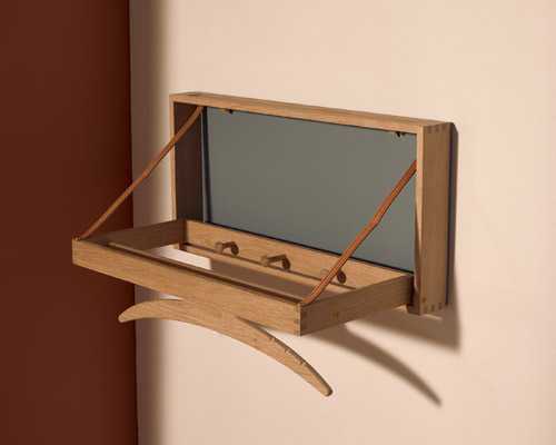 Solid oak wall-mounted valet with hanger, crossbar, leather straps and small accessory groove by Klassik Studio.