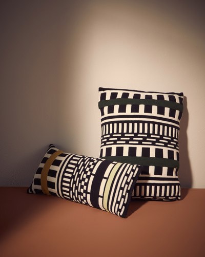 Two striped cylindrical cushions with black and white geometric patterns designed by Nathalie Du Pasquier.