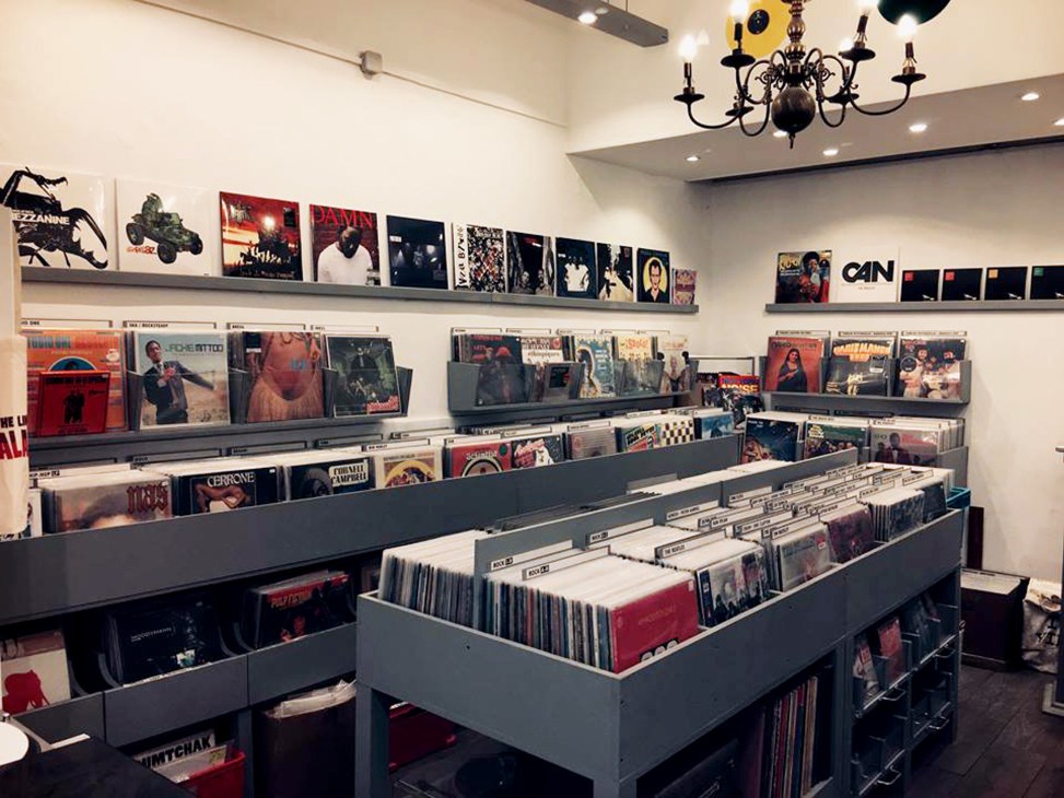 Interior of Cougouyou record shop displaying vinyl records on shelves and in display bins.