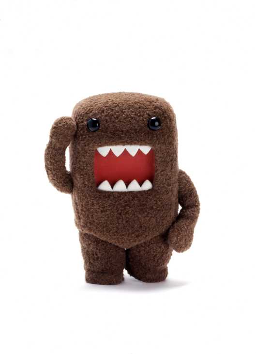 Domo-kun, NHK's mascot, a brown plush character with a square shape, large red mouth with white teeth, and black eyes.