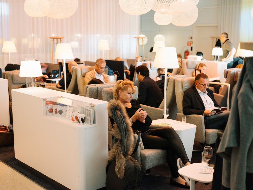 Finnair aircraft cabin interior with passengers seated in modern business class seating.