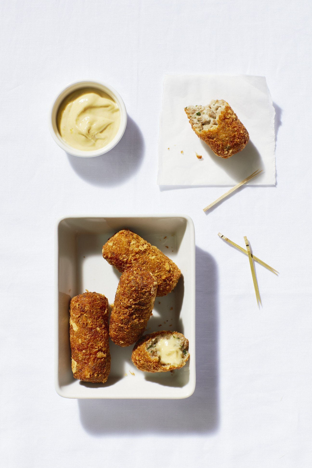 Golden-brown Dutch croquettes served with mayonnaise dipping sauce and garnish