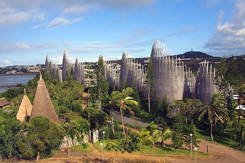 Aerial view of Jean-Marie Tjibaou Cultural Centre with distinctive slatted wooden structures and surrounding landscape in Nouméa, New Caledonia.