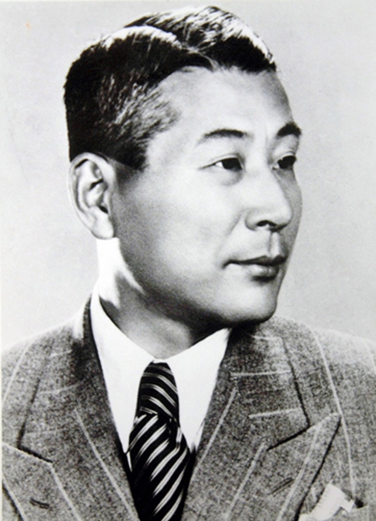Black and white portrait photograph of a man in formal attire from what appears to be the 1940s era