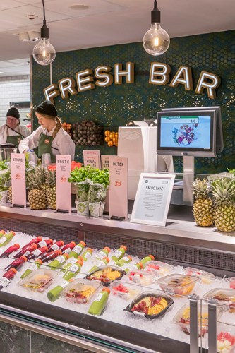 Interior of Stockmann food hall in Helsinki showing fresh produce displays and shoppers