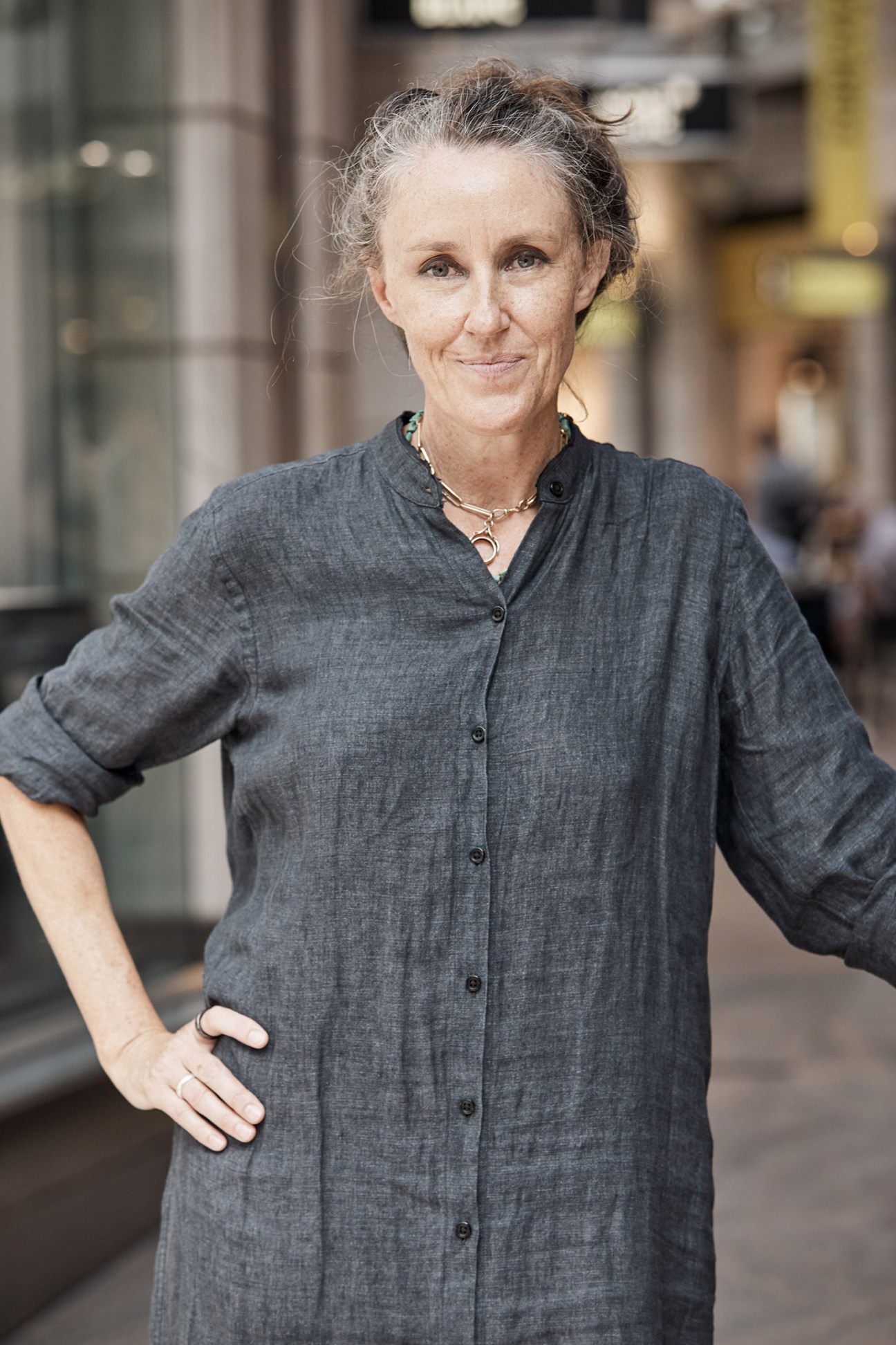 Woman wearing two watches standing on a Sydney street.