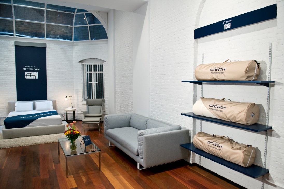 Airweave mattress store interior showing display shelves with packaged mattresses and showroom furniture.
