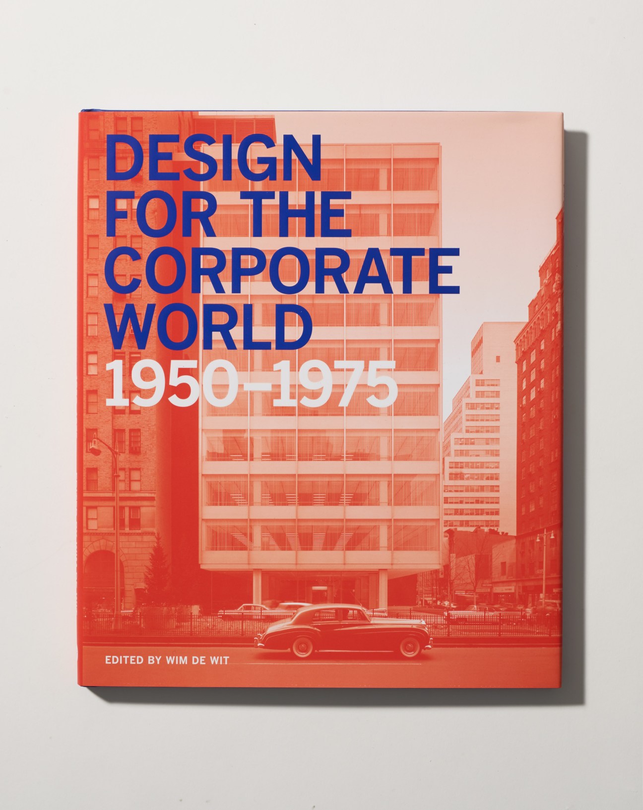 Cover of Design for the Corporate World 1950-1975, edited by Wim de Wit, featuring modernist architecture and a vintage car.