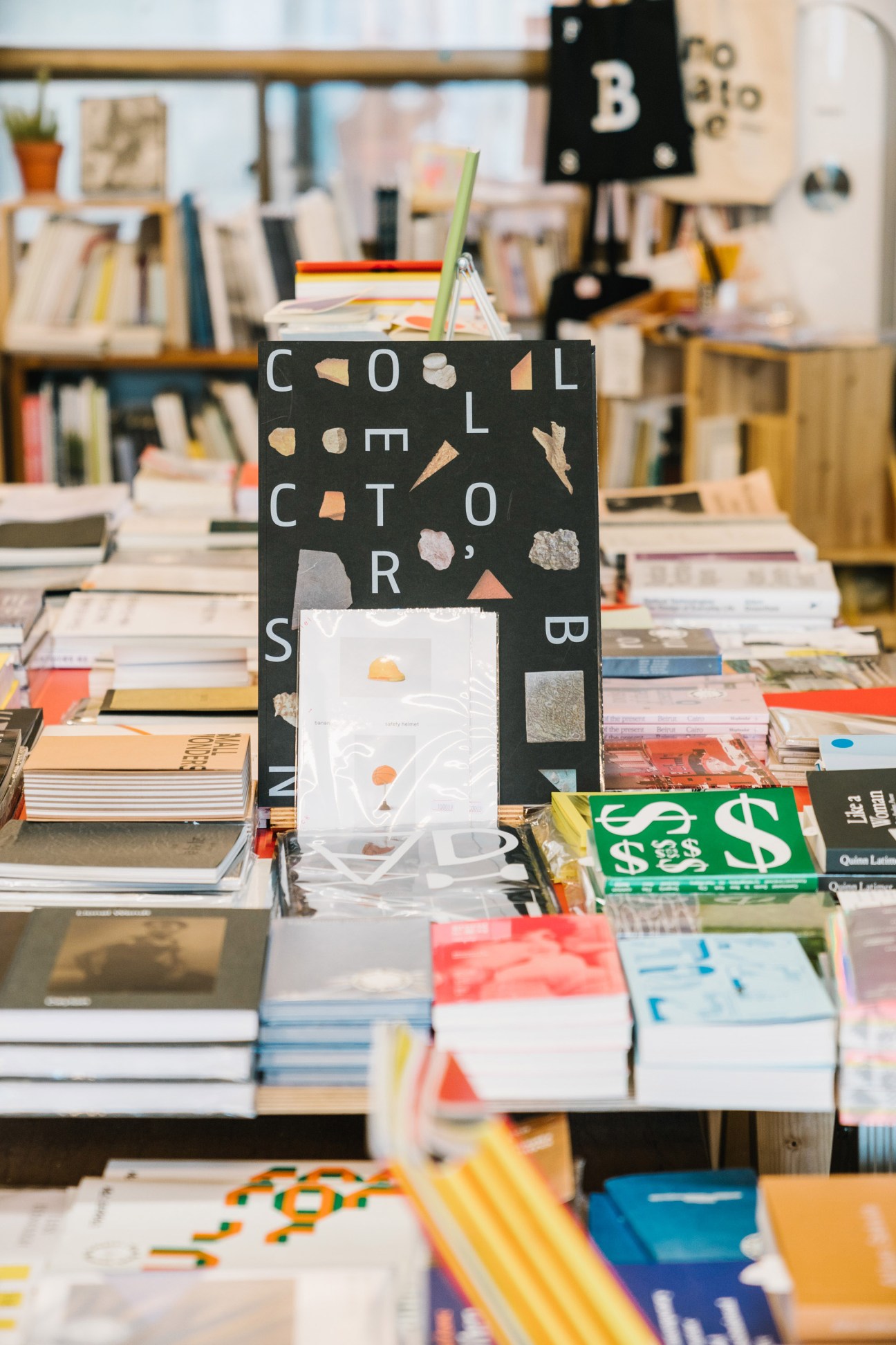 Interior of The Book Society bookstore showing art and design books displayed on tables and shelves
