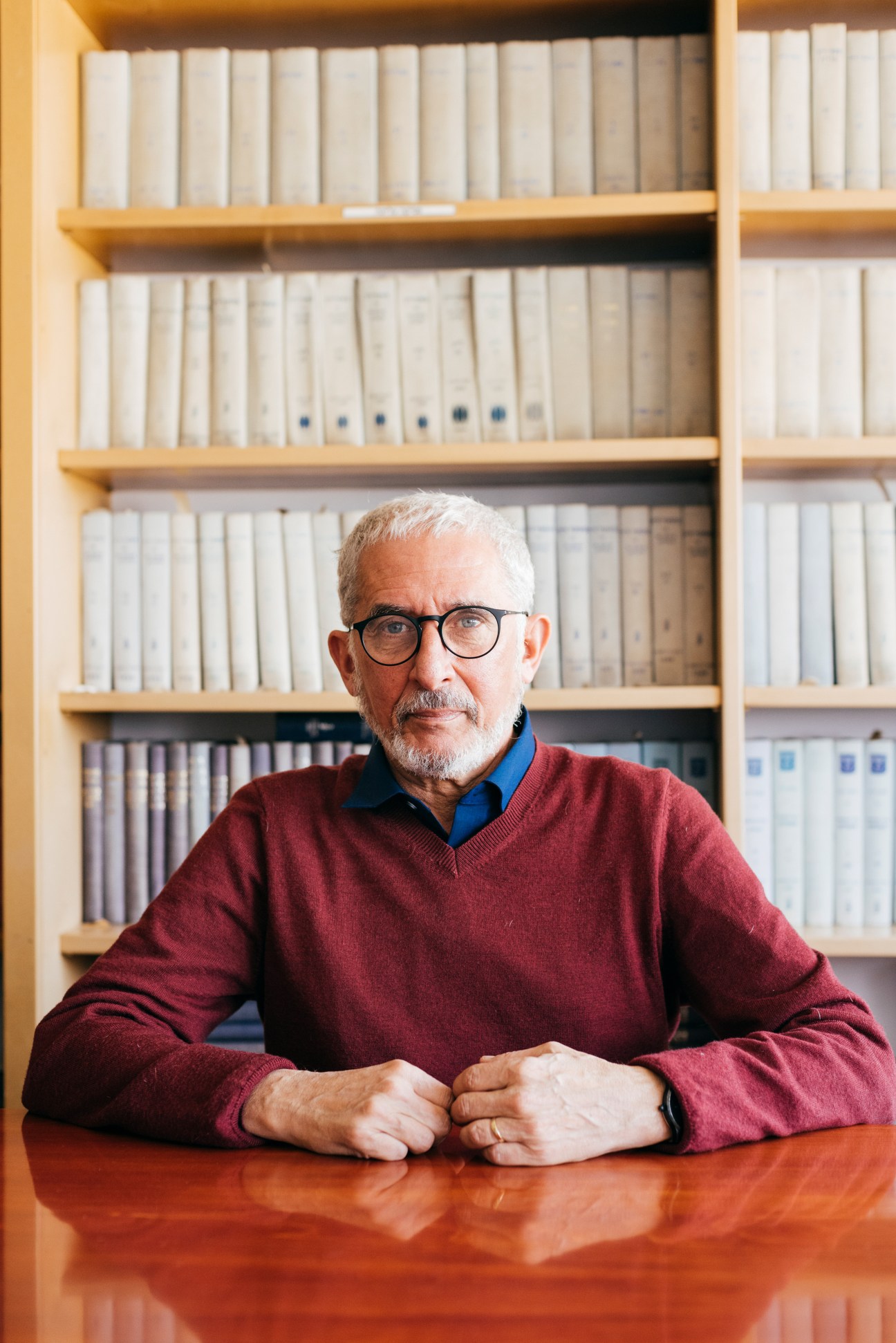 Daniel Seidemann, a lawyer and Zionist campaigner, sits at a wooden desk in front of a bookshelf.
