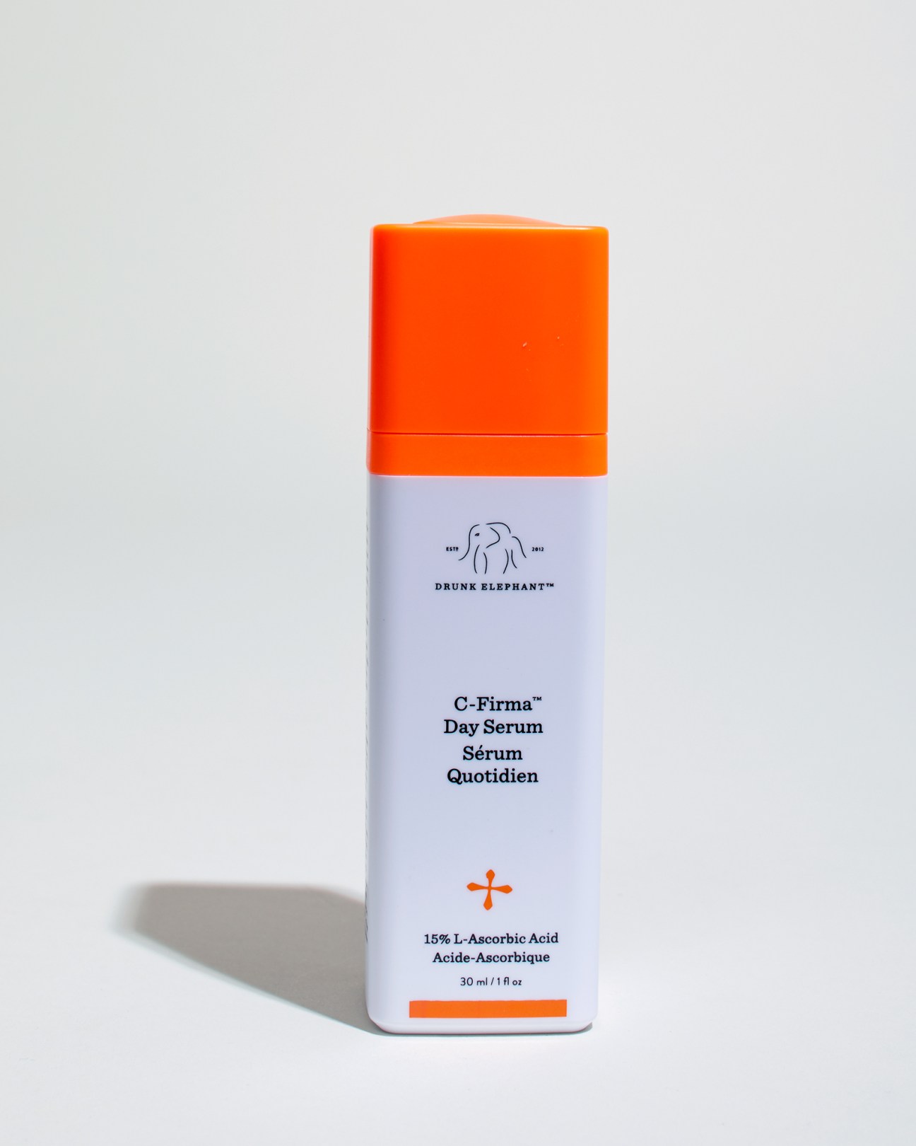 Drunk Elephant C-Firma Day Serum with orange cap and white bottle containing 15% L-Ascorbic Acid.